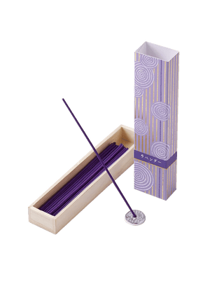 Lavender incense sticks in a light and dark lilac box with foiled Japanese Zen stone garden patterns, with one stick propped on an aluminum incense holder in front of the box.