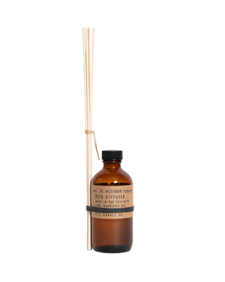 pf candle co wild herb tonic reed diffuser in amber glass bottle with black cap and kraft paper label 3 5oz woody herbaceous home fragrance relaxing spa inspired scent