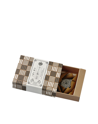 sandalwood japanese incense cones in a brown, black and white criss cross stripe patterned box, half-open to reveal the cones inside.