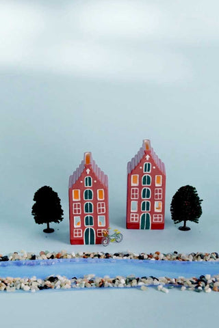 Paddywax Amsterdam House incense holders styled beside miniature canal scene with trees and cobblestones, terracotta ceramic design evoking Dutch architecture, whimsical European home fragrance décor.
