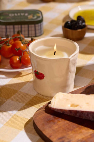 Paddywax Heirloom Tomato Bistro Collection ceramic candle styled with stacked red, yellow and purple heirloom tomatoes on neutral background, bright garden-fresh scene evoking summer markets and Parisian café gift inspiration.