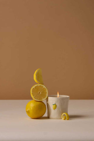 Paddywax Meyer Lemon Bistro Collection ceramic candle styled with fresh lemons on neutral background, vibrant citrus scene evoking sunny kitchen mornings and sunny lemon farm gift inspiration.