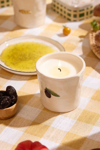 Paddywax Olive Bistro Collection ceramic candle styled with bowl of black olives on neutral background, cozy Mediterranean kitchen scene evoking herbal green aroma and thoughtful gift inspiration.