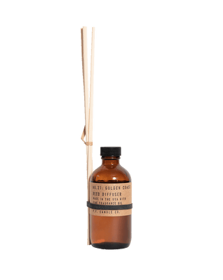 pf candle co golden coast reed diffuser in amber glass bottle with black cap and kraft paper label 3 5oz woody coastal home fragrance relaxing seaside big sur inspired scent
