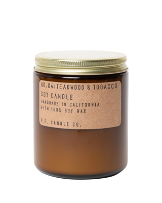 pf candle co teakwood tobacco soy candle in amber glass jar with kraft paper label and gold lid 50 hour burn time clean burn woody leathery citrus home fragrance boyfriend inspired best selling scent