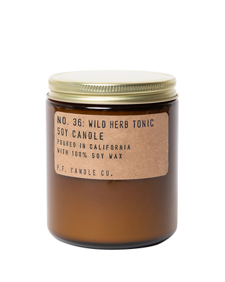 pf candle co wild herb tonic soy scented candle from classic collection in amber jar with kraft paper label and gold lid 50 hour burn time clean burn woody herbaceous fresh home fragrance uplifting calming spa inspired scent